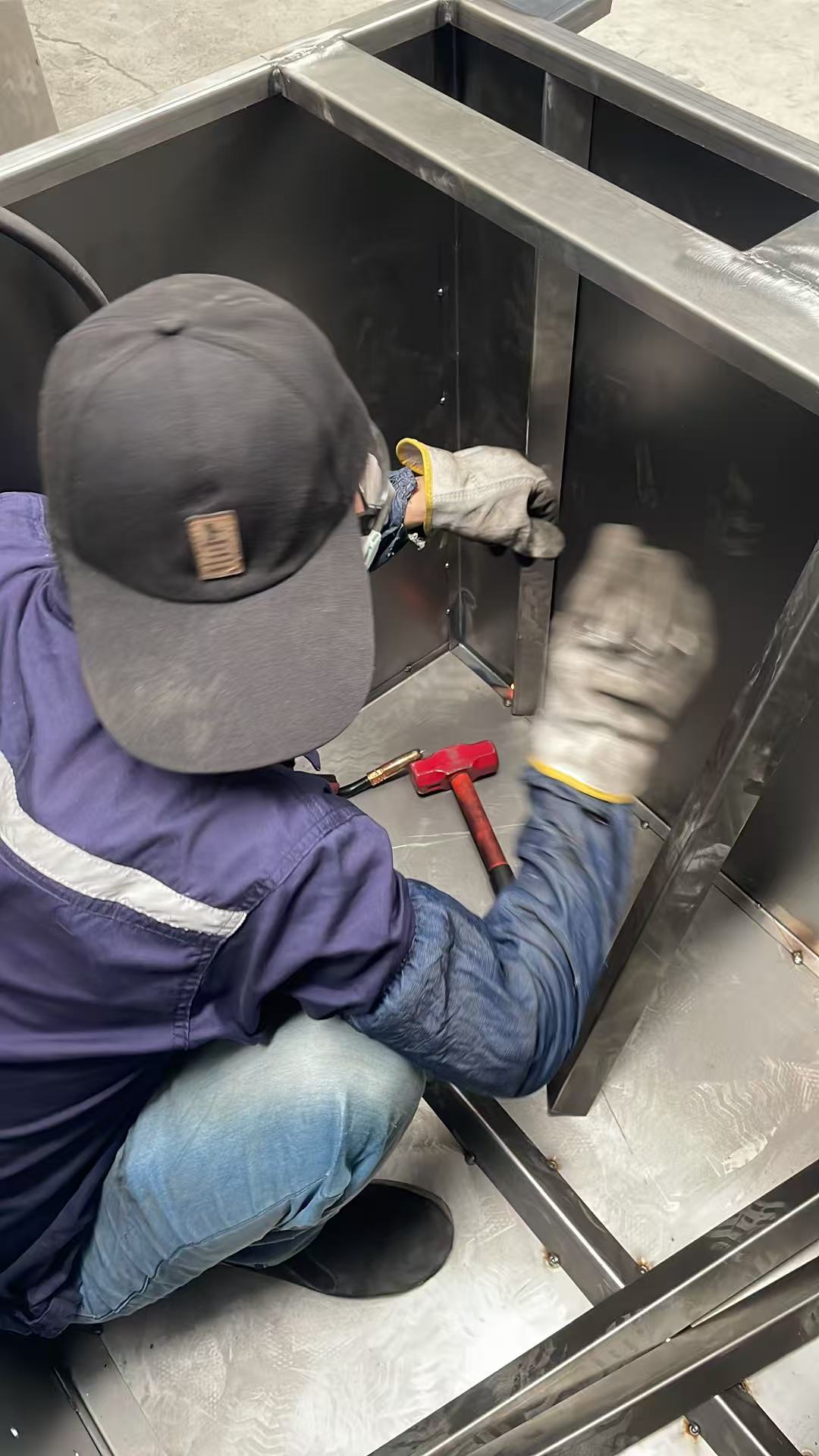 Worker fitting the internal frame inside a dust collector housing